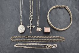 A small selection of silver and white metal jewellery including locket, cross & hedgehog