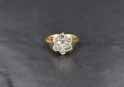 A seven stone brilliant cut diamond daisy cluster ring, total approx 1.35ct in a raised claw set