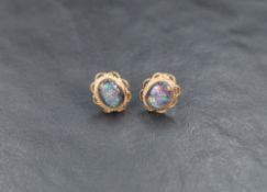 A pair of 9ct gold stud earrings having clear cabouchon stones in collared twist wire mounts