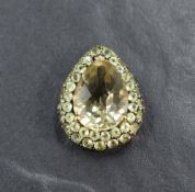 A yellow metal pendant stamped 9k having a facet cut peridot stone within a double border of cut