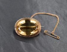 An impressive citrine brooch, the oval cut citrine measuring approximately 17.5mm W x 23.8mm L x 9mm