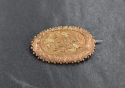 A 9ct gold Mizpah brooch, the oval brooch having floral decoration, engraving and beading to the