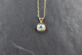 A small blue topaz pendant in a 9ct gold collared mount on a 9ct gold fine link chain, approx