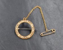 A high carat gold seed pearl brooch, the open circular brooch inlaid with seed pearls with safety