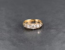 A Victorian 5 stone graduated diamond ring having five old cut diamonds with eight diamond chip