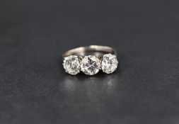 A diamond trilogy ring having three brilliant cut stones totalling approx 2.5ct, each in an 8 claw