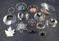 A selection of white metal brooches of various forms including filligree, Celtic knott, etc