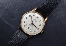 A gent's Smiths Deluxe 9ct gold manual wrist watch having Arabic numeral dial with subsidiary