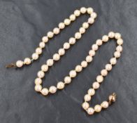 A string of cultured pearls of slightly uneven form having a 9ct gold clasp, approx 16'