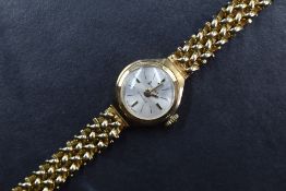 A lady's 9ct gold wrist watch by Accurist having a baton numeral dial to small circular face in a