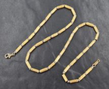 A yellow and white metal necklace, the white metal circular beads alternating with yellow metal
