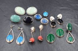 Five pairs of white metal earrings for pierced ears having polished stones in white metal mounts,