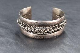 An Egyptian silver cuff bangle having twist decoration and moulded terminals, bearing Egyptian