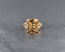 A citrine ring, the emerald cut smoky yellow citrine measuring approximately 9.8mm W x 11.7mm L x
