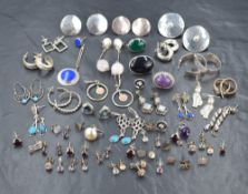 A large selection of white metal stud earrings of various designs for pierced ears, most stamped