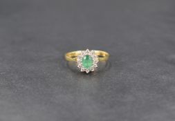 A diamond and emerald cluster ring of petit form on an 18ct gold loop, size L & approx 1.9g