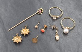 A small selection of yellow metal jewellery including odd earrings, stick pin stamped 15ct, two