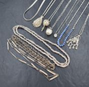 Several silver and white metal pendants, chains and necklaces of various forms including apple
