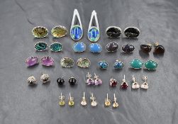 A selection of polished stone and shell earrings, all in white metal mounts for pierced ears, most