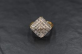 An 18ct diamond cluster ring, the twenty-four round cut tier set diamonds, with a thirty-six