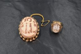 A 9ct shell cameo brooch, depicting the three graces in a bezel setting with twist detail and safety