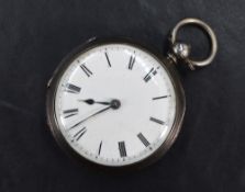 A Victorian silver key wound pocket watch having Roman numeral dial on white face in engraved silver