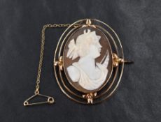 A 9ct shell cameo brooch, possibly depicting Artemis in a bezel setting with decorative openwork