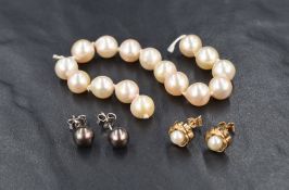 A pair of black pearl stud earrings, mounted on 18ct white gold posts, sold along with a pair of 9ct