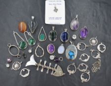 A selection of white metal jewellery including artisan made pendants, charms etc