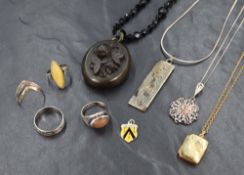 A selection of silver and other jewellery, including a silver ingot necklace, a jet floral locket on