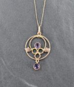 An Edwardian style yellow metal pendant and chain stamped 9ct having amethyst decoration in a