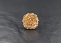 A 1908 half sovereign coin, set within a 9ct gold ring having decorative pierced work to the