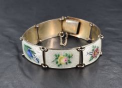 A Norwegian silver and enamel panel bracelet having painted flowers on white guilloche enamelled