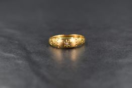 An 18ct diamond gypsy style ring, the central diamond chip in a sunburst setting, having engraving