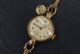 A lady's vintage 9ct gold wrist watch by Movida having an Arabic numeral dial with subsidiary