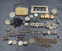 An assortment of silver and white metal jewellery, including a silver belt buckle, various other