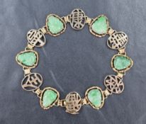 A Chinese panelled bracelet stamped 10K having six oval panels with jade style carved buddhas