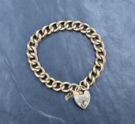 A 9ct gold curb link bracelet, having a heart padlock and safety chain, approximately 15cm