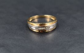 A 9ct two-tone gold ring, the white gold platform set with seven round cut diamonds in a tension