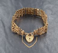 A 9ct gold 5 bar gate bracelet having padlock clasp, approx 11.6g, some wear to bracelet and