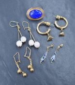 An assortment of gold and yellow metal earrings, including drop examples and a pair of hoops, 12g