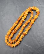 A butterscotch amber bead necklace, comprising numerous graduating asymmetrical beads, 34cm, 47.