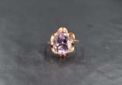 A 9ct gold amethyst ring, the central oval cut amethyst measuring approximately 11.4mm x 9.6mm x