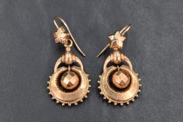 A pair of 19th century rose metal drop earrings, having an open work design with articulated faceted