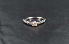 A 9ct white gold diamond set wedding band and matching engagement ring of delicate shaped form, both