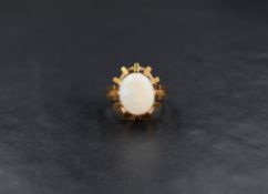 An 18ct gold opal gypsy style ring, the central opal cabochon set in a raised openwork setting,