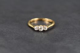 A diamond trilogy ring having three old cut diamonds in claw set mounts, approx 0.225ct total on a