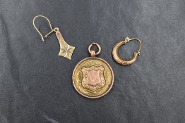 A small selection of gold jewellery comprising a 9ct gold hoop earring, a 9ct gold drop earring