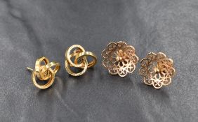 Two pairs of 9ct gold stud earrings, one pair of pierced floral design, the other of a textured knot
