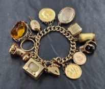 A 9ct gold curb link charm bracelet having a padlock clasp and thirteen charms including a sovereign
